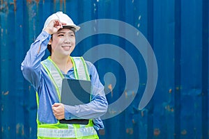 Asian woman young teen happy smile worker as engineer working with safety in logistic import export warehouse cargo container area