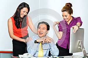 Asian Womanizer boss flirting at the office photo
