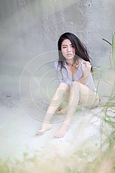 Asian womansitting outdoor in countryside. Young smiling woman outdoors portrait.