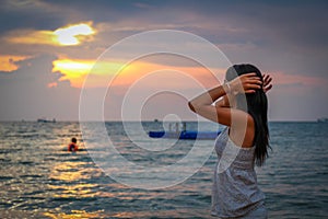 An Asian women admiring the sunset on Ba Keo Beach, Phu Quoc, Vietnam