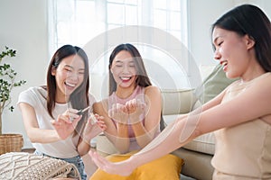 Asian Women applying nail polish together