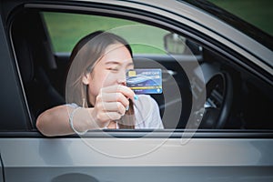 Asian women attractive and young sitting in car, holding credit card mockup