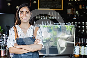 Asian women Barista smiling and using coffee machine in coffee shop counter - Working woman small business owner food and drink