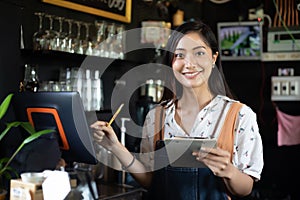 Asian women Barista smiling and using coffee machine in coffee shop counter - Working woman small business owner food and drink