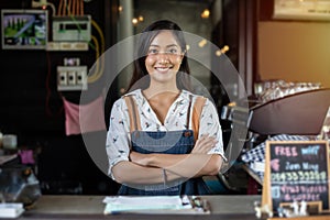 Asian women Barista smiling and using coffee machine in coffee shop counter - Working woman small business owner food and drink