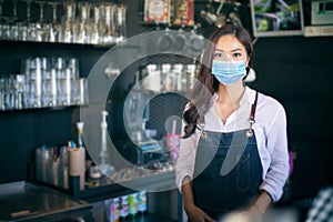 Asian women Barista smiling and using coffee machine in coffee shop counter - Working woman small business owner food and drink