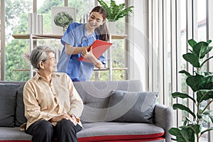 Asian women are being cared for by nurses who monitor health and physical therapy for elderly women living alone at home. by