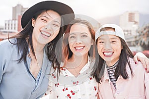 Asian women best friends having fun outdoor - Happy trendy girls laughing together - Millennial generation, bonding, friendship