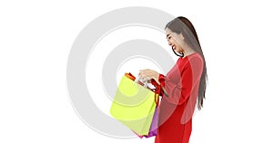 Asian women carry a shopping bags, she moving her body and posts, concept for shopaholic woman, studio shot on white background