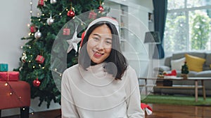 Asian women celebrate Christmas festival. Female teen wear Christmas hat relax happy smiling looking at camera enjoy xmas winter