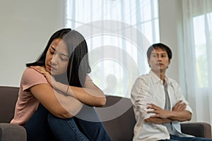 Asian women are disappointed and saddened after an argument with their husband.