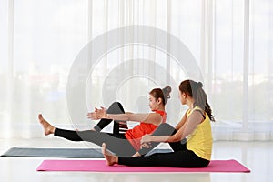 Asian women doing Boat pose variation