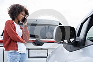 Asian women driver check for damage after a car accident before taking pictures and sending insurance. Online car accident