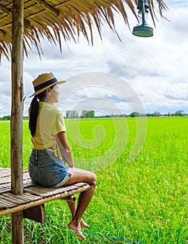 Asian women at a Eco farm homestay with a rice field in central Thailand