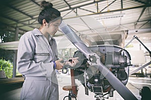 Asian women Engineers and technicians are repairing aircraft.