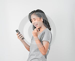 Asian women of happy smiling are listening to music from white headphones. And using hands touch to use various functions.