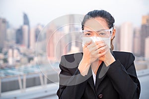 Asian women have to use masks and goggles to protect against pollution from dust and prevent the infection from viruses