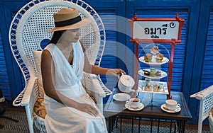 Asian women having a Luxury high tea with snack and tea in a luxury hotel