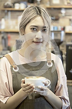 Asian Women Holding Coffee Cup  At Cafe