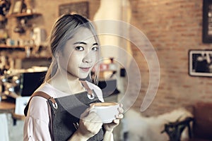 Asian Women Holding Coffee Cup  At Cafe