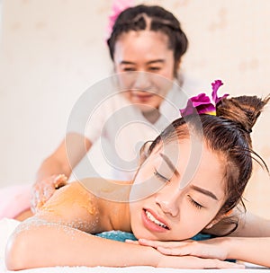 Asian women is hurting while recieving Spa massage