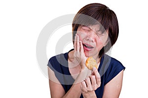 Asian women with intense toothache pain after biting cookie