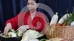 Asian women intent on mixing and seasoning pickled vegetables to make kimchi. which is intentionally traditional Korean food.