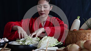 Asian women intentionally cook pickles and salt fresh vegetables to make kimchi. which is intentionally traditional Korean food.