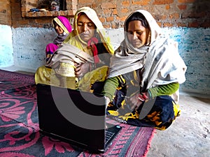 asian women learning about laptop technology togather at village home in india January 2020