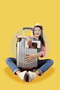 Asian women long hair smiling wear Straw hat, sitting in hand holding passport book and travel bag .Young girl ready to travel