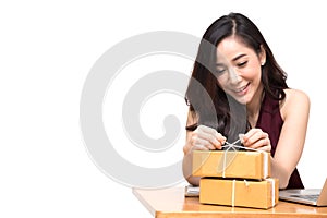 Asian women packing parcel on the table