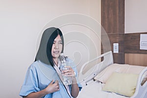 Asian women patient having or symptomatic reflux acids at hospital,Gastroesophageal reflux disease,Drinking water
