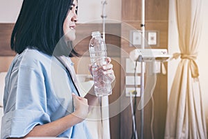 Asian women patient having or symptomatic reflux acids at hospital,Gastroesophageal reflux disease,Drinking water