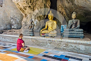 Asian women pilgrim worships the Buddha statues at cave of Wat Tham Khao Wong