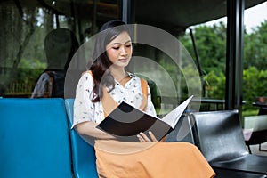 Asian women reading book and smiling and happy Relaxing in a coffee shop