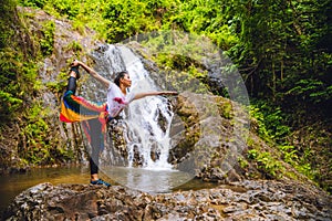 Asian women relax in the holiday. Asian women relax in the holiday. Play if yoga at waterfall On the Moutain. exercise, good
