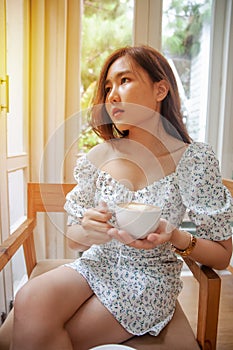 Asian women relax with hot coffee latte art