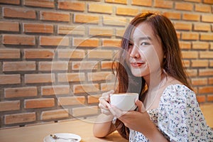 Asian women relax with hot coffee latte art