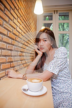 Asian women relax with hot coffee latte art