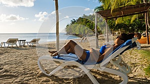 Asian women relaxing on a beach chair during sunset at Saint Lucia caribbean