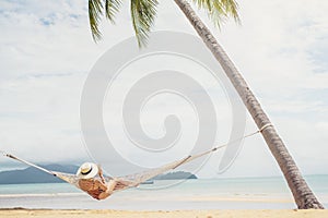 Asian women relaxing in hammock summer holiday on beach