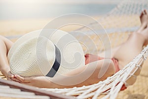 Asian women relaxing in hammock summer holiday on beach