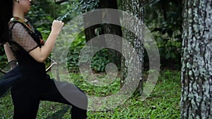 Asian women running fastly in the jungle while holding an arrow and a bow