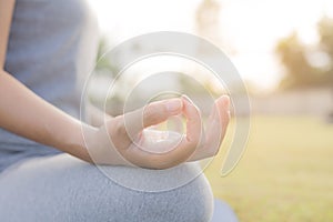 Asian women`s hands are practicing yoga and meditating in the morning light