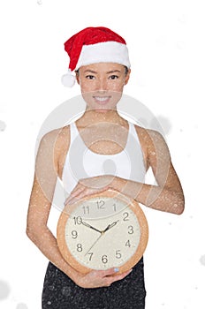 Asian women in a Santa`s hat with a clock