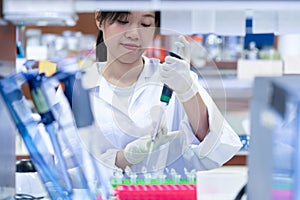 Asian women scientist with making research in clinical laboratory