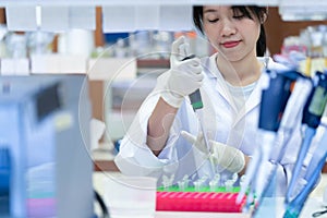 Asian women scientist with making research in clinical laboratory