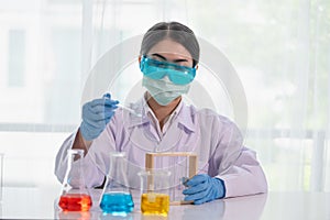 Asian women scientist with test tube making research in clinical laboratory  Science and chemistry concept  Medical technologist