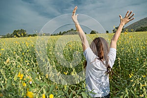 Asian women with slightly curly is raising arms to the sky in y