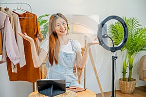 Asian women SME freelance Fashion designer are thinking of designing clothes in the cloth room and Online business seller